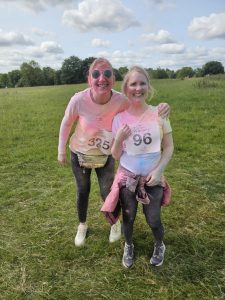 Two team members covered in powder paint after completing the race.