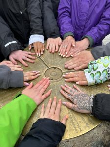 group of hands on the Snowdon summit.
